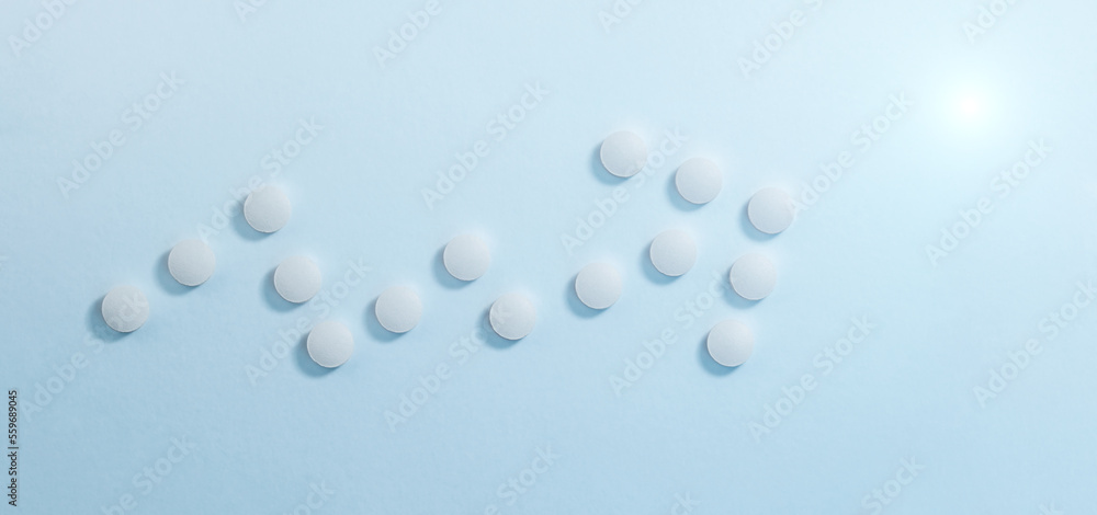 Growth arrow of white pills in the form of graph. Medicine concept Growth arrow of white pills in the form of graph. Medicine concept