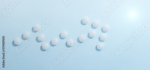 Growth arrow of white pills in the form of graph. Medicine concept