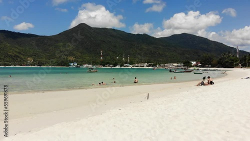 Flying close over sandy beach and tourists at Ao Chaloklum Bay in Koh Phangan, Thailand, with a Drone photo