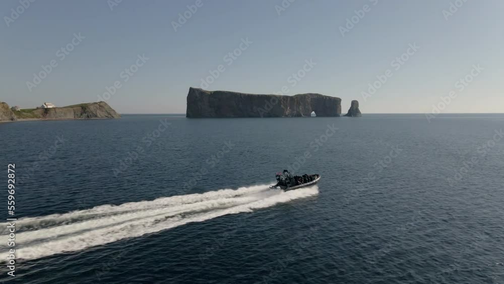 Zodiac boat passing in front of famous Perce rock Zodiac boat passing in front of famous Perce rock