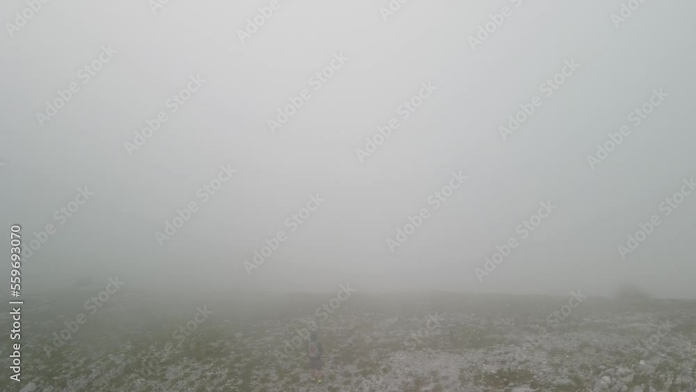 orbit view of man on top of mountain view with thick clouds in Montenegro orbit view of man on top of mountain view with thick clouds in Montenegro