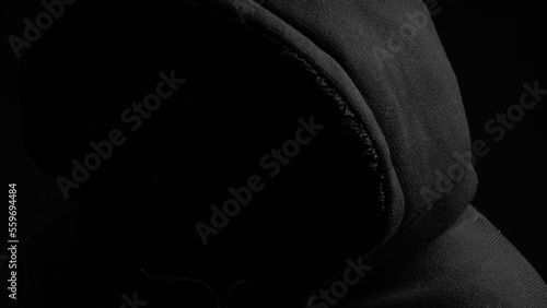Silhouette in casual sportswear with hood. Faceless unrecognizable man without identity