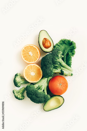 Vegetables and fruits. Sliced avocado, orange and broccoli. Concept of healthy diet foodstuffs.