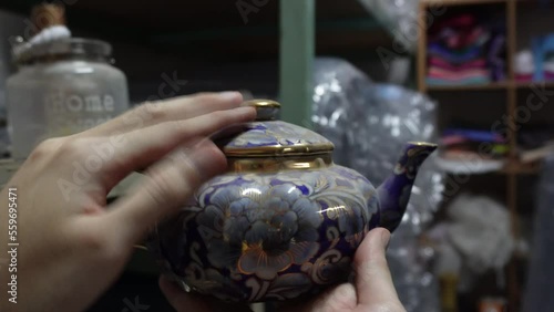 dusting off old antique teapot