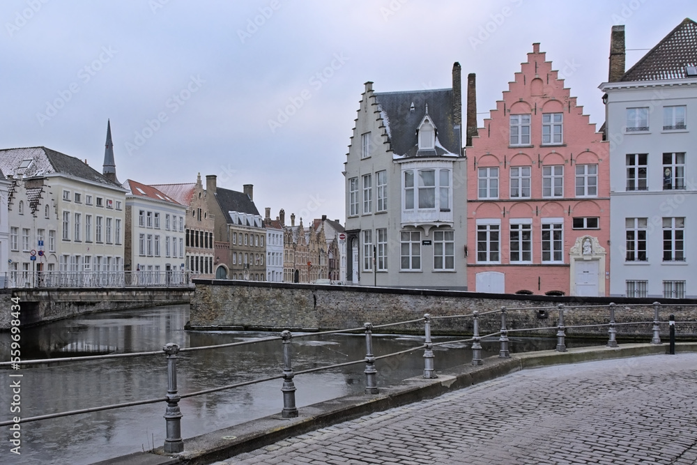 Old medieval houses along a canal on a winter morning in Bruges, Flanders, Belgium
