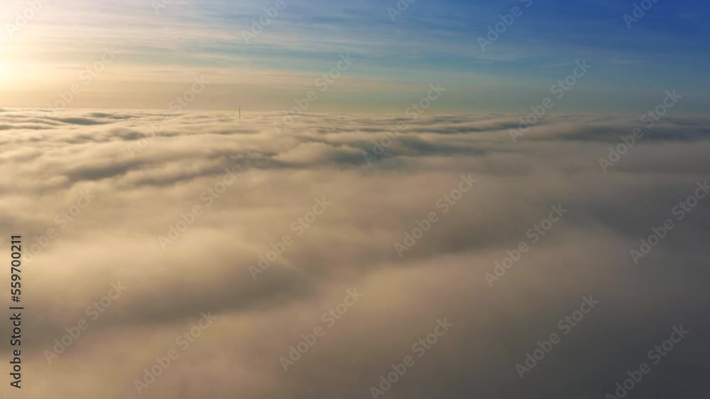 4K Flying above the clouds with beautiful golden clouds at sunrise and blue sky 4K Flying above the clouds with beautiful golden clouds at sunrise and blue sky