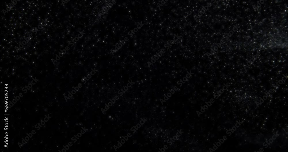 Glowing dust particles on black screen overlay. Filmed with RED camera in slow motion. Abstract shapes background. High quality 4k footage Glowing dust particles on black screen overlay. Filmed with RED camera in slow motion. Abstract shapes background. High quality 4k footage