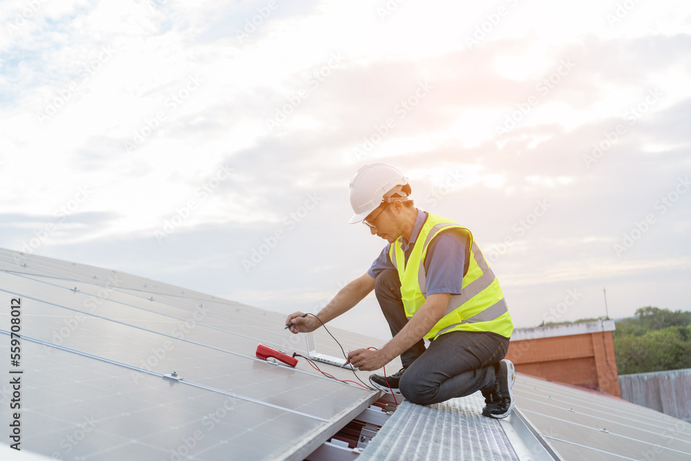 Engineers wearing a uniform walking on roof inspect and check solar cell panel, solar cell is smart ecology energy sunlight alternative power factory concept. Engineers wearing a uniform walking on roof inspect and check solar cell panel, solar cell is smart ecology energy sunlight alternative power factory concept.