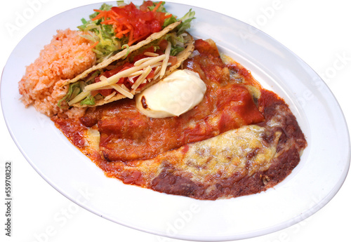 Combination Mexican food, refried beans, rice, taco, salad and enchilada on a white plate