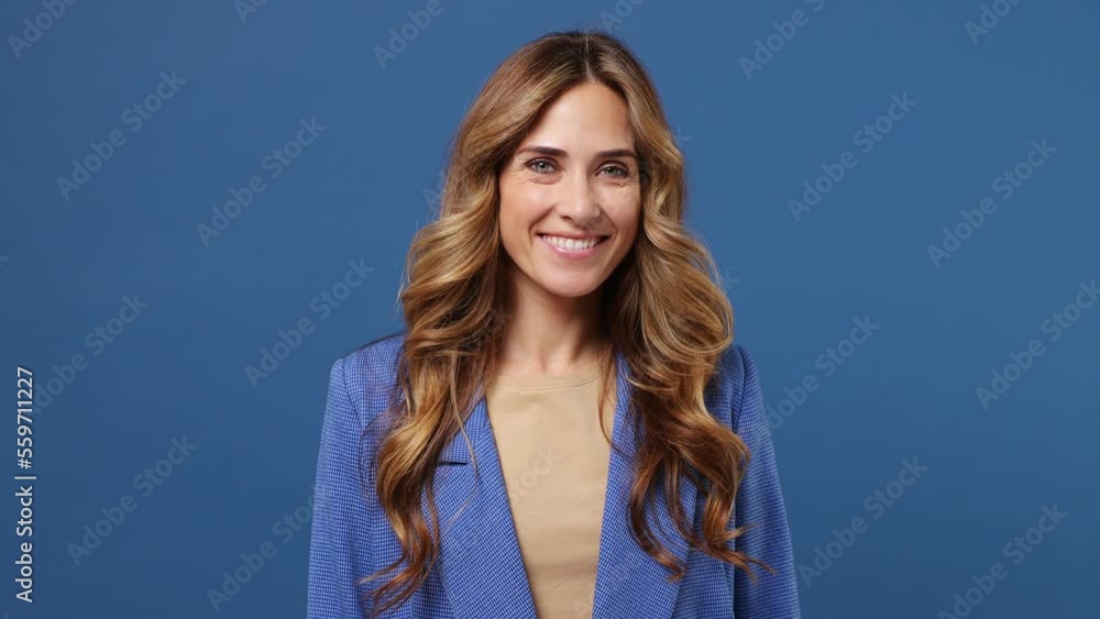 Young happy fun cool cheerful caucasian woman wearing suit jacket beige t-shirt looking camera smiling isolated on plain dark royal navy blue color background studio portrait. People lifestyle concept Young happy fun cool cheerful caucasian woman wearing suit jacket beige t-shirt looking camera smiling isolated on plain dark royal navy blue color background studio portrait. People lifestyle concept