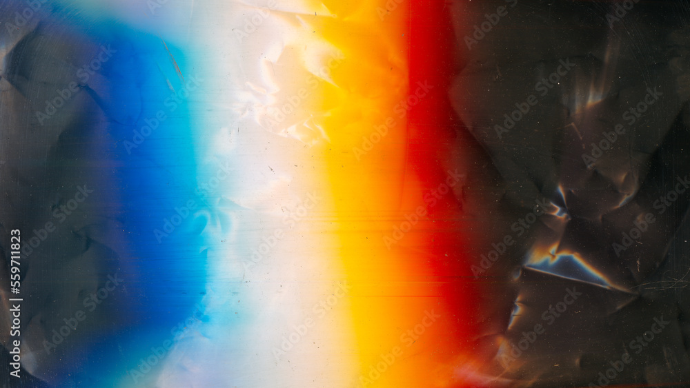 Aged film texture. Dust scratches noise. Weathered foil. Orange blue white rainbow color light flare on dark crushed grunge abstract background. - obrazy, fototapety, plakaty 