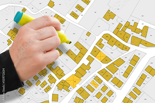 Imaginary cadastral map with buildings, land parcel and vacant plot printed on paper photo