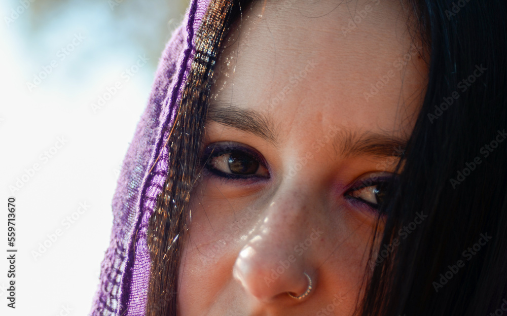 woman with lilac headscarf feminist. Portrait of brown eyes and lilac makeup. Deep and luhcador look. Concept of feminism and gender violence. March 8, International Women's Day woman with lilac headscarf feminist. Portrait of brown eyes and lilac makeup. Deep and luhcador look. Concept of feminism and gender violence. March 8, International Women's Day