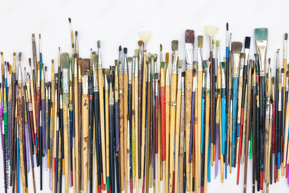 Many brushes for painting on a white background, top view. Many brushes for painting on a white background, top view.