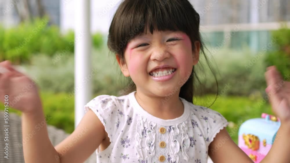 Portrait Funny little asian girl big smiling child looking at camera after makeup herself, enjoying childhood testimonial concept, Positive child, 4k footage, Slow Motion Portrait Portrait Funny little asian girl big smiling child looking at camera after makeup herself, enjoying childhood testimonial concept, Positive child, 4k footage, Slow Motion Portrait