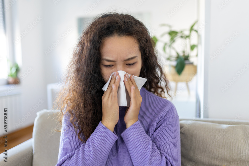 Sick desperate Asian woman has flu. Rhinitis, cold, sickness, allergy concept. Pretty sick woman has runnning nose, rubs nose with handkerchief. Sneezing female. Brunette sneezing in a tissue Sick desperate Asian woman has flu. Rhinitis, cold, sickness, allergy concept. Pretty sick woman has runnning nose, rubs nose with handkerchief. Sneezing female. Brunette sneezing in a tissue