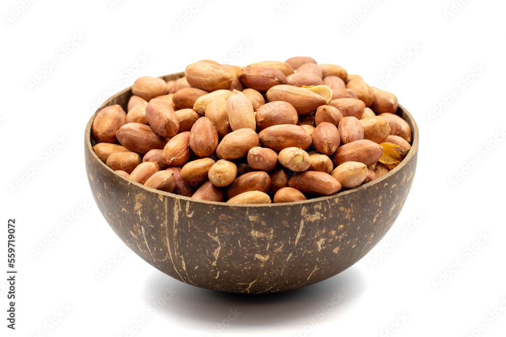 Peanuts isolated on white background. Peanuts in a coconut bowl. Studio shoot. close up Peanuts isolated on white background. Peanuts in a coconut bowl. Studio shoot. close up