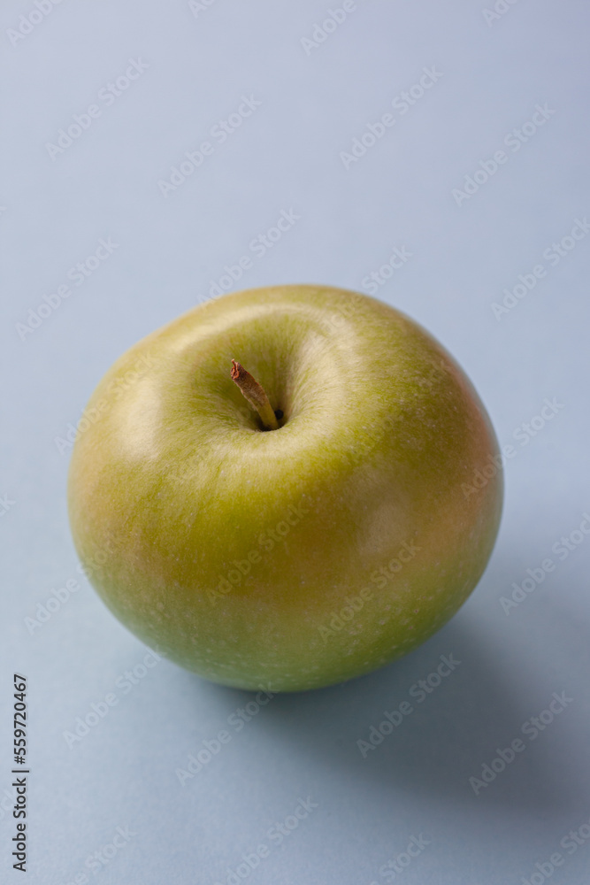 Creative pattern with apples on bright light blue background Creative pattern with apples on bright light blue background