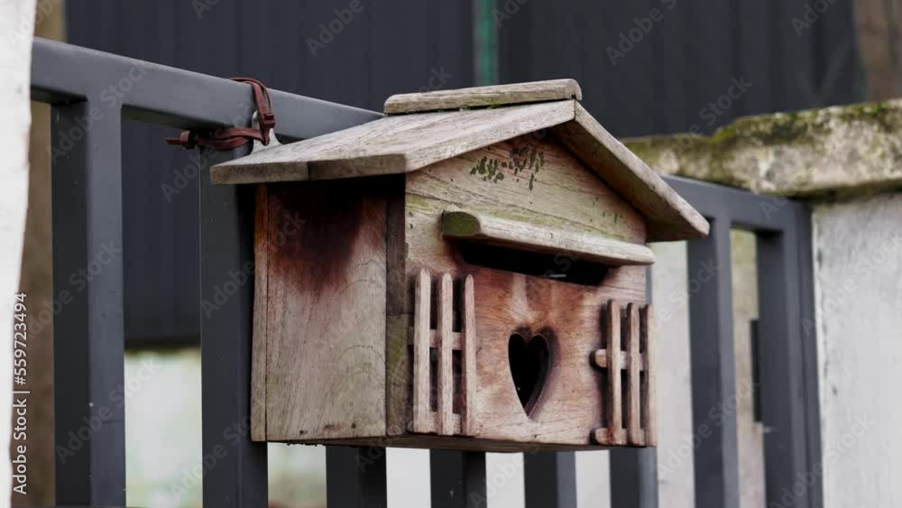 Wooden carved mailbox for love letters on Valentine day with heart shaped letterbox slot Wooden carved mailbox for love letters on Valentine day with heart shaped letterbox slot