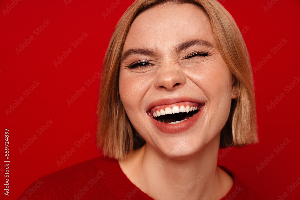 Young blonde woman with short hair smiling and looking at camera Young blonde woman with short hair smiling and looking at camera