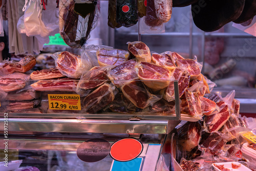 Variety of fresh Spanish jamon, ham and meat on the market in Barcelona, Spain