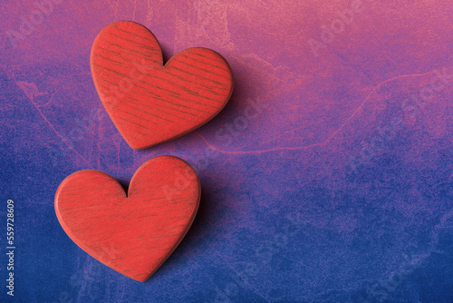 Close up of two valentines hearts on pink blue stone background with copy space. Valentines day greeting card template