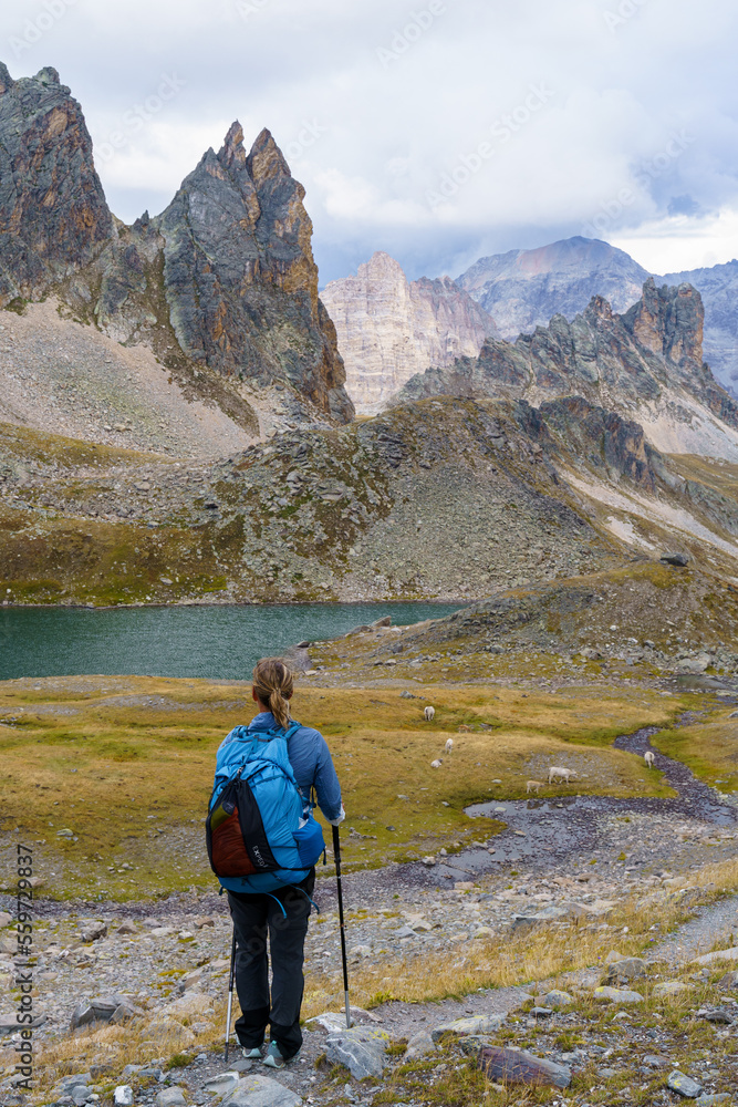 A hiker enjoys the scenic view of the mountains in the Vallée de la Clarée in the French Alps.