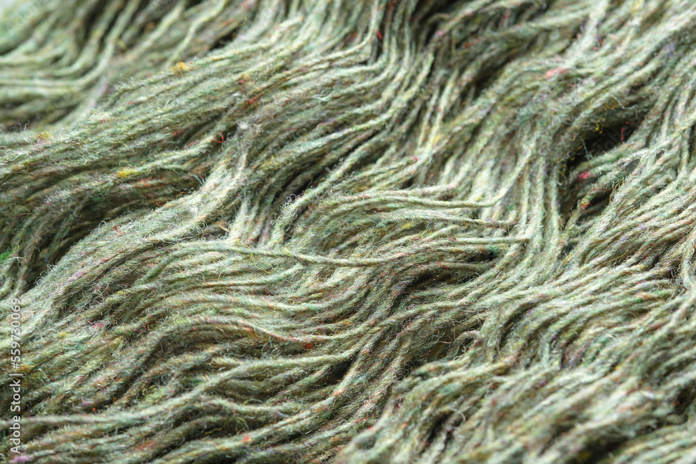Threads of natural organic sheep wool. Unwound skein of olive green knitting yarn. Threads of natural organic sheep wool. Unwound skein of olive green knitting yarn.