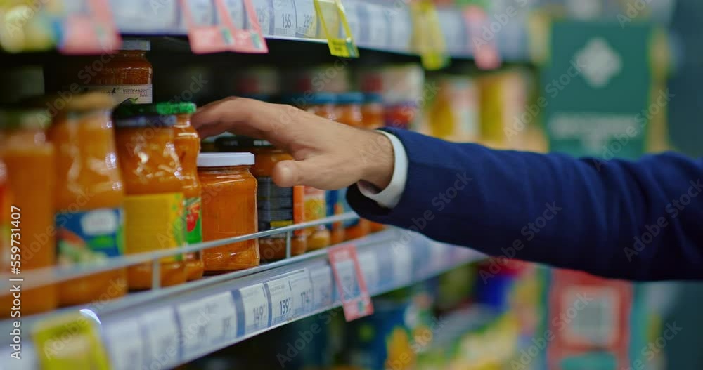 man choosing tomato sauce in food store, taking jar from supermarket shelves, closeup, 4K, Prores man choosing tomato sauce in food store, taking jar from supermarket shelves, closeup, 4K, Prores