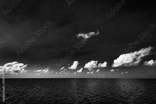 Dramatic sea view  monochrome  seascape  white clouds dark deep ocean bay. Coastline in black and white  abstract sky. Exotic Mediterranean tropical sea view. Dream motivation and inspire Earth nature