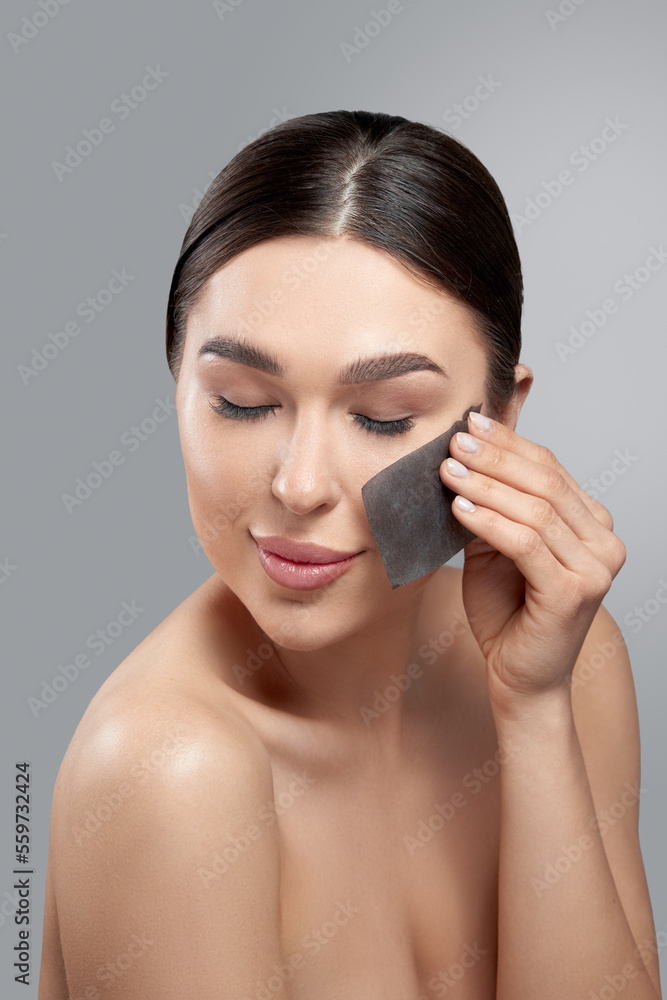 Skin Care. Woman removing oil from face using blotting papers. Closeup Portrait Of Beautiful Healthy Girl With Nude Makeup. Perfect Soft Skin With Oil Absorbing Tissue Sheets. Beauty Concept Skin Care. Woman removing oil from face using blotting papers. Closeup Portrait Of Beautiful Healthy Girl With Nude Makeup. Perfect Soft Skin With Oil Absorbing Tissue Sheets. Beauty Concept
