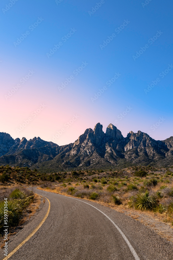 Organ Mountains, Desert Peaks National Monument in Las Cruces, Doña Ana County, New Mexico, Southwestern USA, curved single lane paved road to the mountain at sunrise near Sugarloaf Peak.