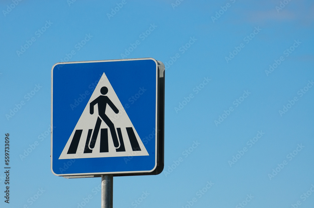 road sign pedestrian crossing close-up against the blue sky road sign pedestrian crossing close-up against the blue sky