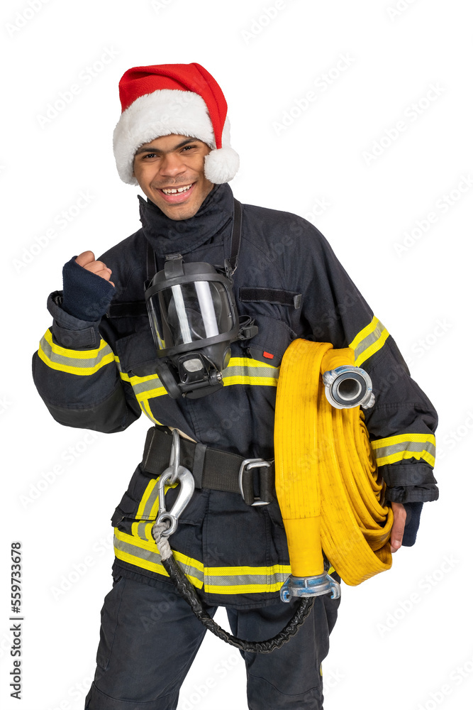 Exited young African American fireman in uniform and red Santa hat holding fire hose and looking at camera isolated on white background Exited young African American fireman in uniform and red Santa hat holding fire hose and looking at camera isolated on white background