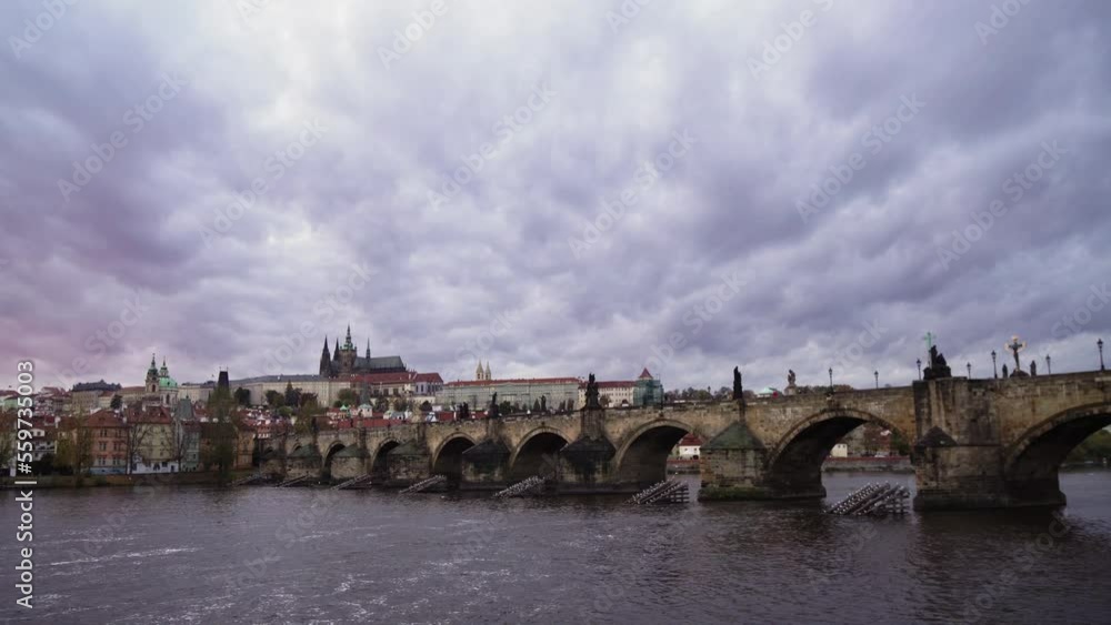 Charles Bridge or Karluv most in Prague, side panning left view, moving clouds and Vltava river Charles Bridge or Karluv most in Prague, side panning left view, moving clouds and Vltava river