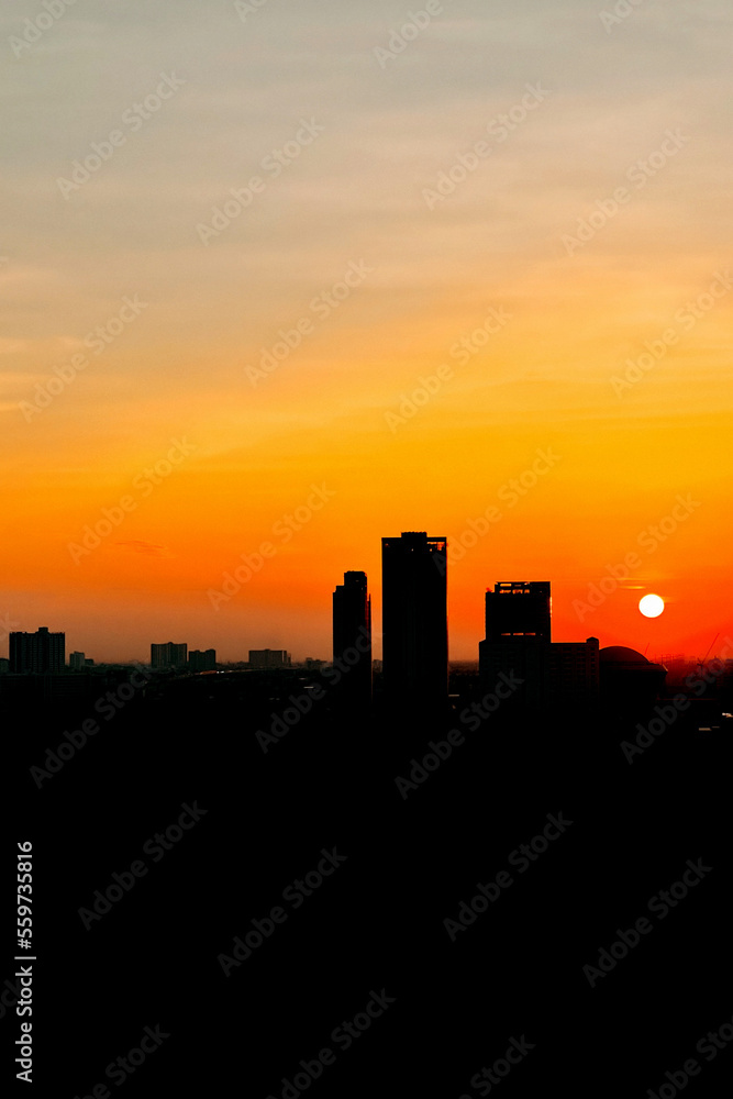The silhouette sunset over Bangkok city skyline. verticle picture