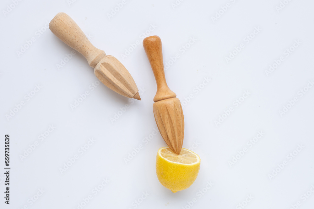Fresh lemon with wooden juicer on white background. Copy space Fresh lemon with wooden juicer on white background. Copy space