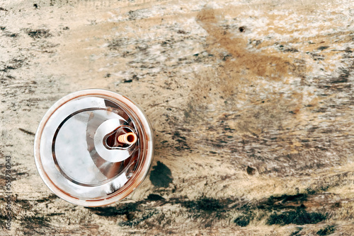 Top view of ice chocolate milk in a clear plastic glass on a wooden table