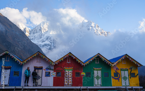 Fototapeta Naklejka Na Ścianę i Meble -  Colourful cabins in kambachen in front of big snow-covered mountains 