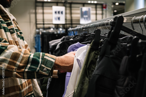 Close up of person chooses clothes in store