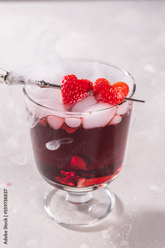 Valentine's day cocktail with dry ice on dark background Valentine's day cocktail with dry ice on dark background