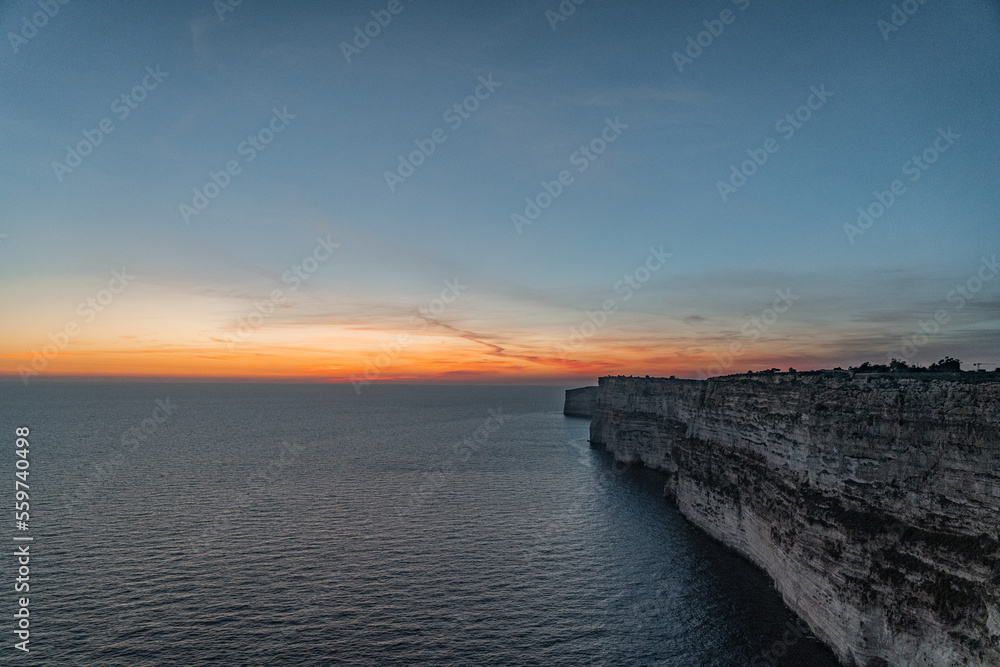 Sunset over the sea and the beautiful cliffs.