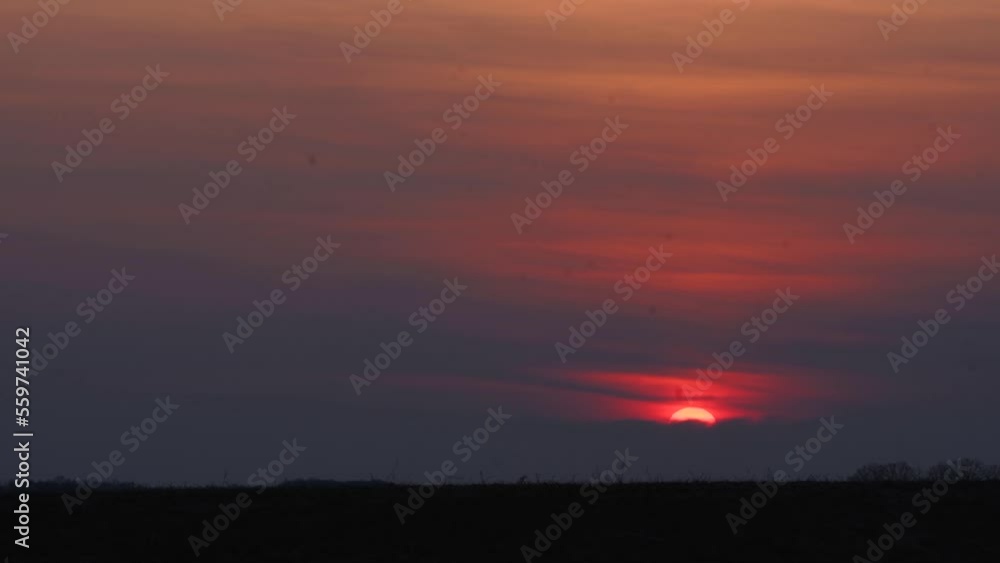 Sunset timelapse, dramatic sundown landscape, view nature sunset in the pink sky. Big bright orange sun moves down. Awesome landscape of sky and dark the horizon. Amazing colors of the setting sun. Sunset timelapse, dramatic sundown landscape, view nature sunset in the pink sky. Big bright orange sun moves down. Awesome landscape of sky and dark the horizon. Amazing colors of the setting sun.