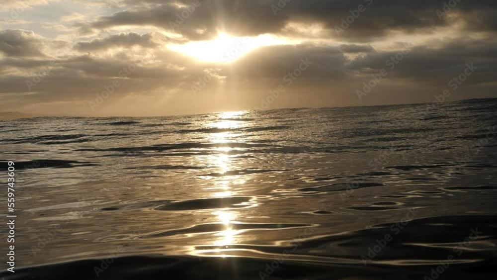 The ocean glimmers with the warm glow of the rising sun. As the sun continues to rise, its rays turn the water into a dazzling display of shimmering light. The vibrant sunrise is mirrored in the ocean The ocean glimmers with the warm glow of the rising sun. As the sun continues to rise, its rays turn the water into a dazzling display of shimmering light. The vibrant sunrise is mirrored in the ocean