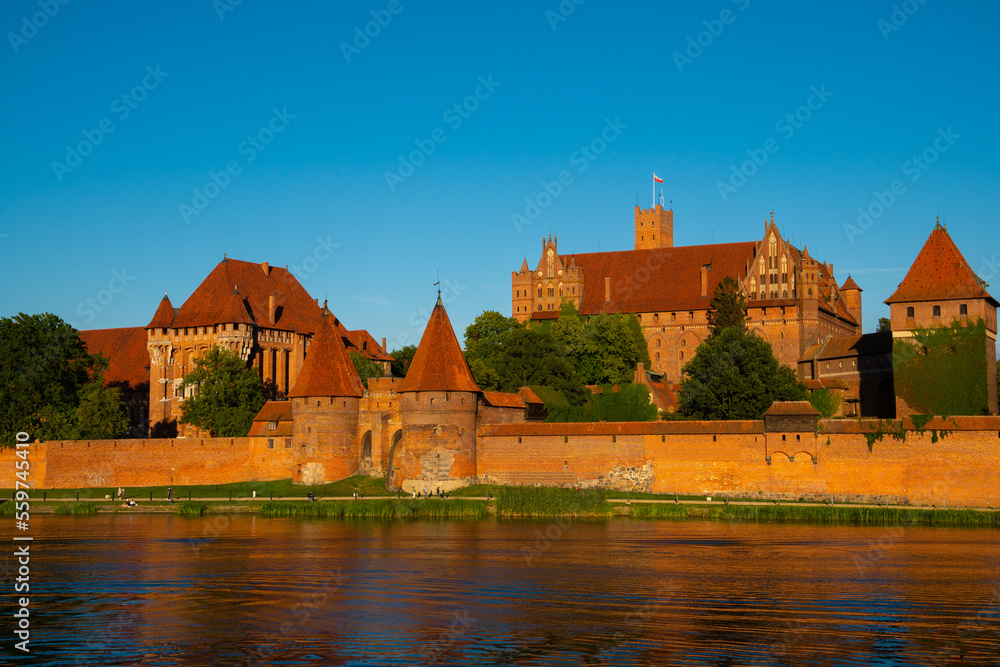 Marienburg Castle the largest medieval brick castle in the world in the city of Malbork at sunset