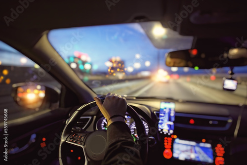 Driving a car at night in the city with navigation
