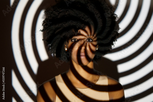 Young woman with spiral shadow on body photo