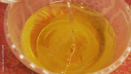 Pouring Lye solution into natural organic oil saponification soap making photo