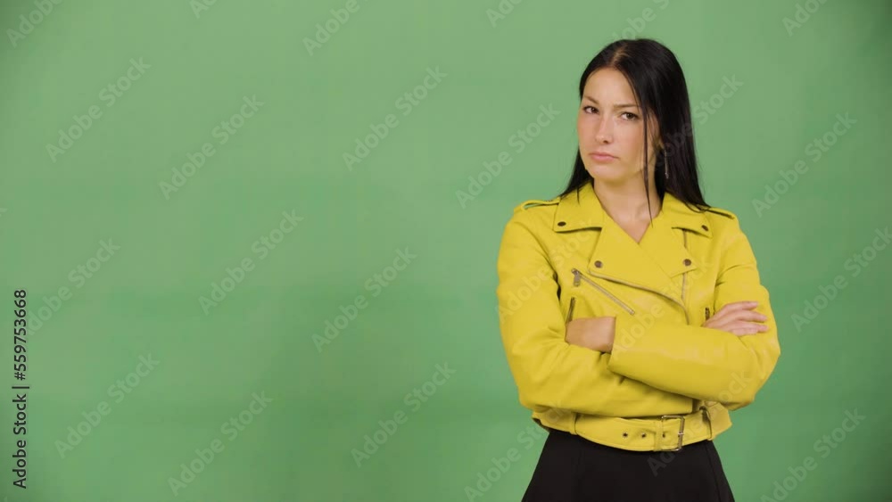 A young beautiful Caucasian woman shakes her head at the camera - green screen studio A young beautiful Caucasian woman shakes her head at the camera - green screen studio