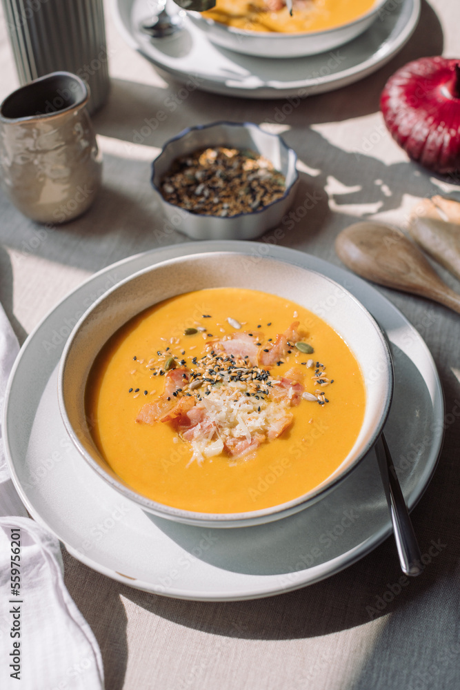 Family meal. Pumpkin cream soup with seeds and bacon. Vegetable seasonal soup. Family meal. Pumpkin cream soup with seeds and bacon. Vegetable seasonal soup.